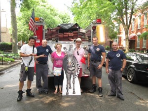 Library employees and CFD firefighters with the library zebra